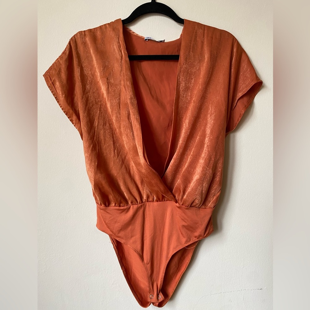burnt orange bodysuit with deep v neckline